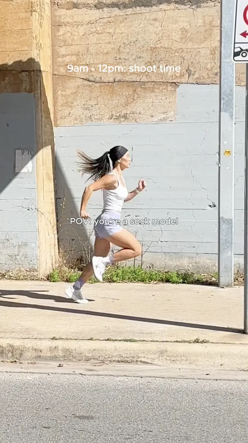 Behind the scenes of the Balega shoot: Lizzie running past a concrete wall.