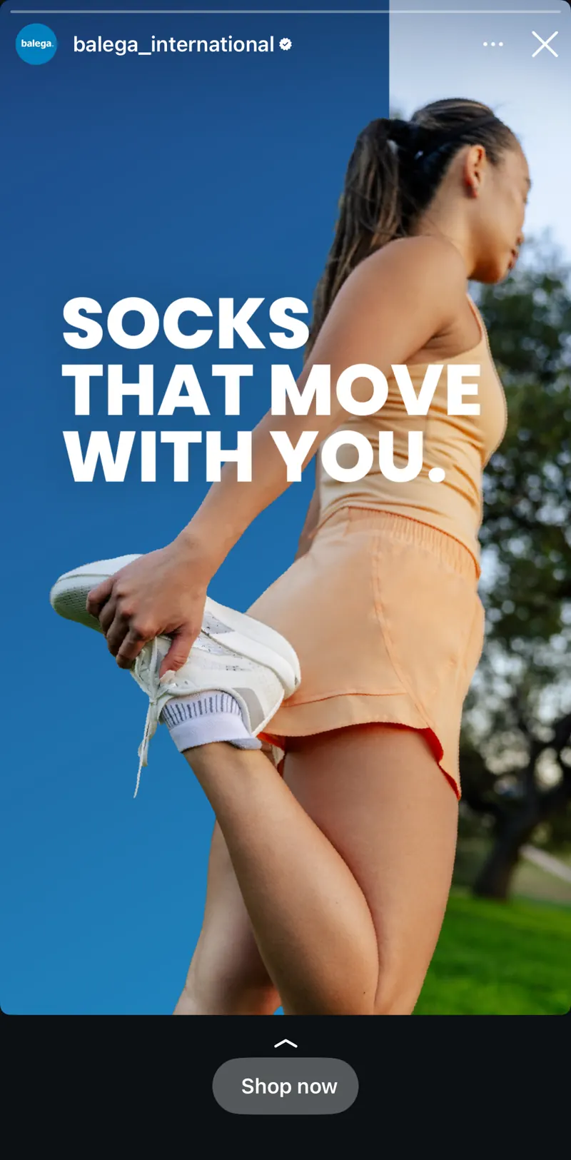Balega Instagram ad featuring Lizzie stretching in a peach running set, with the line “Socks that move with you.”